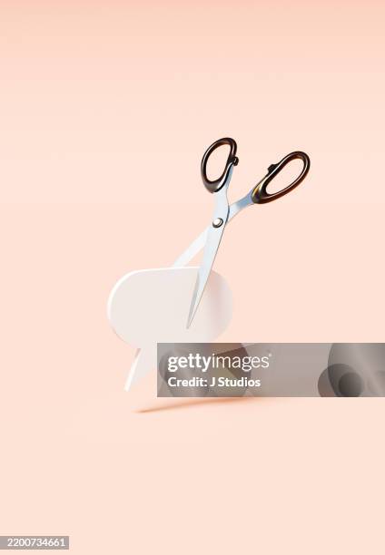 oversized speech bubble ready to be cut by scissors – the threat to dialogue - censura fotografías e imágenes de stock