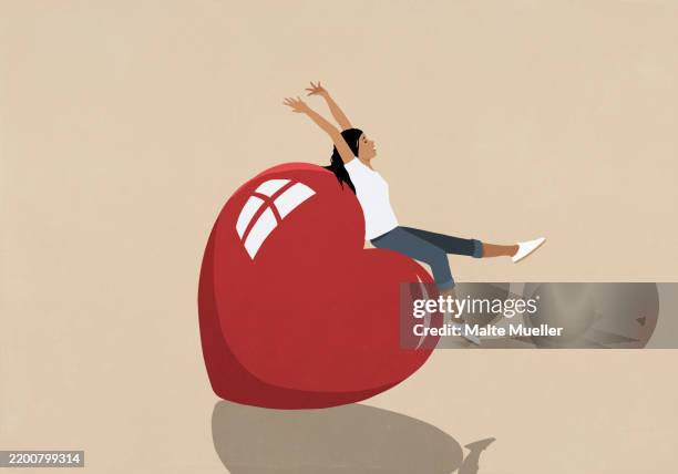 illustrations, cliparts, dessins animés et icônes de carefree, happy young woman on top of large red heart - jeunes femmes