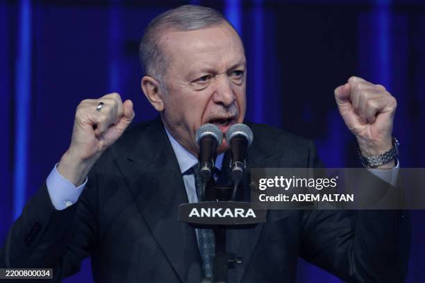 Turkey's President Recep Tayyip Erdogan gestures as he addresses a speech during the Justice and Development Party , as part of the 8th Ordinary...