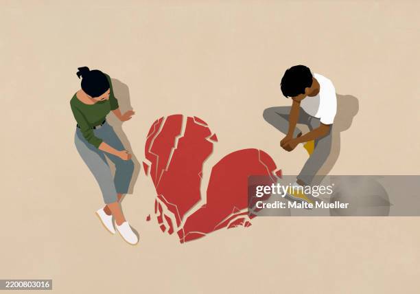 high angle view couple looking down at broken heart on beige background - separation stock illustrations