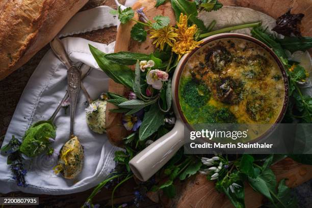 gourmet snails, filled with herbs and garlic on a highly decorated table - herb sauce stock pictures, royalty-free photos & images