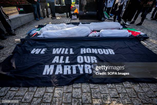 Corpses representing the many thousands of dead - considered martyrs - since the conflict in Gaza began 500 days ago. Pro-Palestinian protestors...