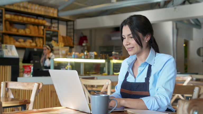https://media.gettyimages.com/id/2200820191/video/female-business-owner-of-a-coffee-shop-working-on-laptop-and-looking-very-happy.jpg?b=1&s=640x640&k=20&c=VfmnLxU6ifrJhuFS1csLsL6jLHWw9UOmrf2bSxj72JE=
