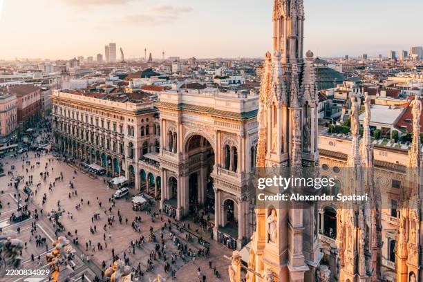 galleria vittorio emanuele ii shopping gallery and piazza del duomo square at sunset, aerial view, milan, italy - aguja chapitel fotografías e imágenes de stock