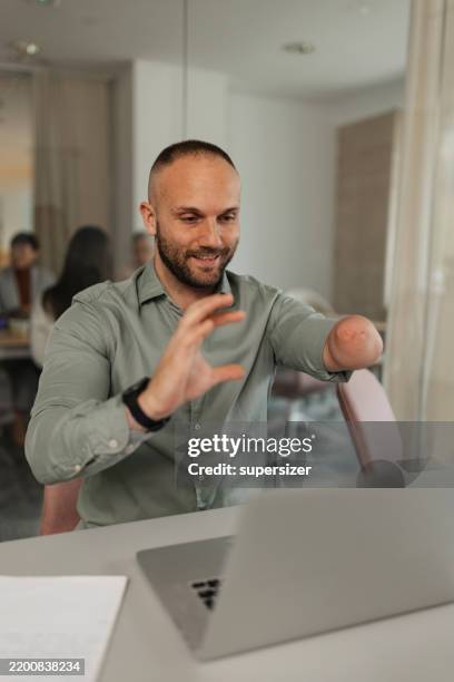 smiling businessman analyzing data at work - amputee working stock pictures, royalty-free photos & images