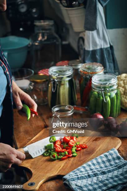fermented foods - preparing fermented mixed chili peppers - i was turning into a vegetable stock pictures, royalty-free photos & images