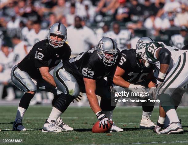 Barret Robbins, Offensive Tackle and Center for the Oakland Raiders prepares to snap the football as, Quarterback Rich Gannon calls the play on the...