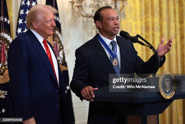 Gold legend Tiger Woods speaks alongside U.S. President Donald Trump during a reception honoring Black History Month in the East Room of the White...