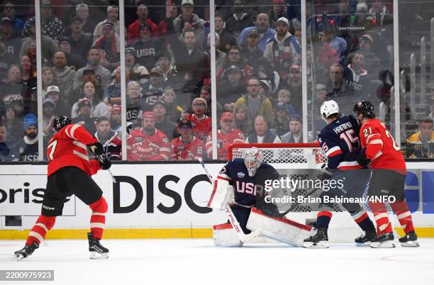 Connor McDavid of Team Canada scores the game-winning goal against Connor Hellebuyck of Team United States during the first overtime period of the 4...