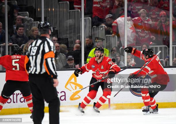 Connor McDavid of Team Canada celebrates with Devon Toews and Mitchell Marner after scoring the game-winning goal during the first overtime period of...