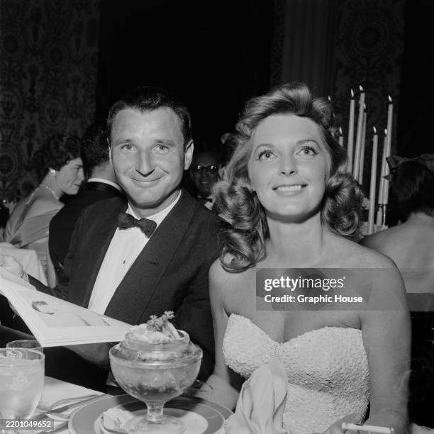 American actor, singer and pianist Bobby Troup, wearing a tuxedo and bow tie, and his wife, American actress and singer Julie London, who wears an...
