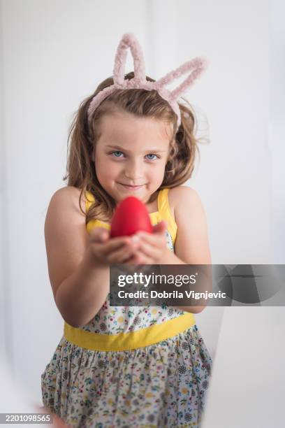 beautiful young girl holding an easter egg - bunny suit stock pictures, royalty-free photos & images
