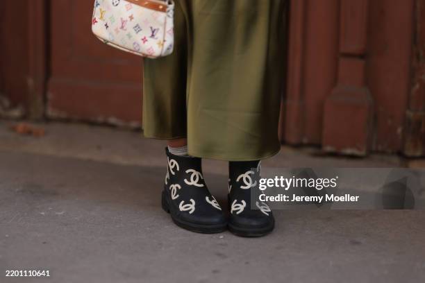 Karin Teigl seen wearing Zara green silk / satin long skirt, Louis Vuitton white / colorful monogram logo pattern canvas mini bag and Chanel black...