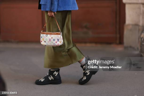Karin Teigl seen wearing Zara blue suede leather jacket, Zara green silk / satin long skirt, Louis Vuitton white / colorful monogram logo pattern...