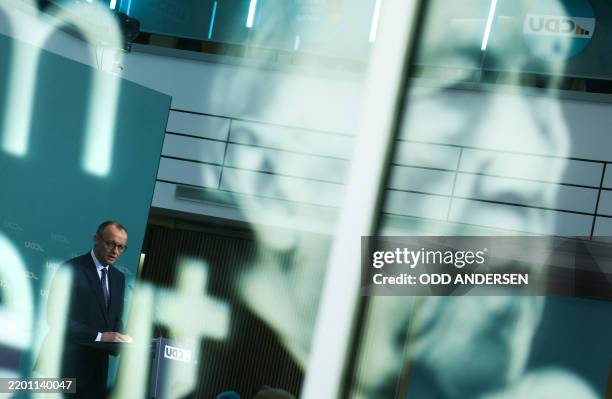 Photo of former German Chancellor Konrad Adenauer is seen as leader of Germany's Christian Democratic Union Friedrich Merz addresses a press...