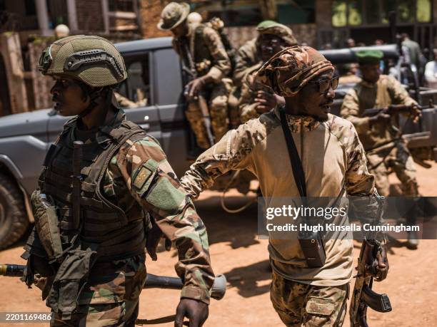 Rebels guard a unit of surrendering Congolese police officers who will be recruited into the rebel group on February 22, 2025 in Bukavu, Democratic...
