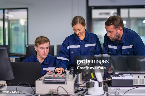 Engineers are working at robotics workshop. Engineers are working at robotics workshop.