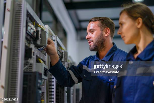 engineers are working at robotics workshop. - datacenter power stock pictures, royalty-free photos & images