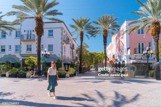 woman walking along espanola way in miami beach florida us - miami imagens e fotografias de stock