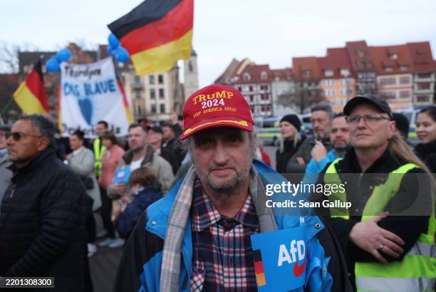 Man with an AfD flag wears a Trump "Make America Great" cap at an election campaign rally of the far-right Alternative for Germany before German...