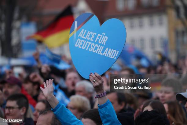 Woman holds up a heart-shaped placard that reads: "Alice for Germany!" in reference to AfD chancellor candidate Alice Weidel and that is also very...