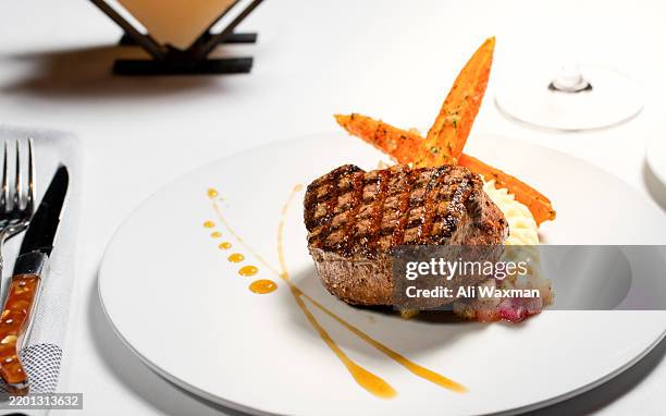 delicious filet mignon steak over potatoes purée in a fine dining restaurant - costeleta comida imagens e fotografias de stock