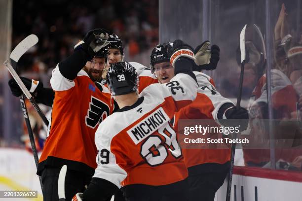 Owen Tippett of the Philadelphia Flyers celebrates with Sean Couturier, Egor Zamula, and Matvei Michkov after scoring a goal against the Edmonton...