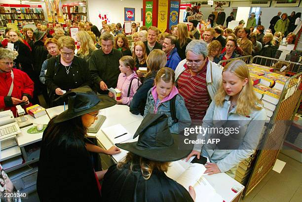 Customers queue to buy copies of "Harry Potter and the Order of the Phoenix" in Helsinki 22 June 2003 at a bookstore which opened for a few hours on...