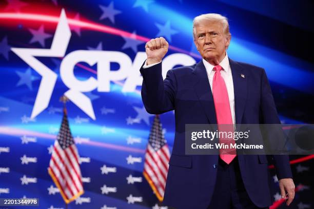 President Donald Trump reacts to the crowd while arriving at the Conservative Political Action Conference at the Gaylord National Resort Hotel and...