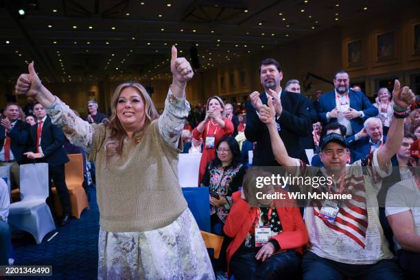 Members of the audience react as U.S. President Donald Trump speaks at the Conservative Political Action Conference at the Gaylord National Resort...