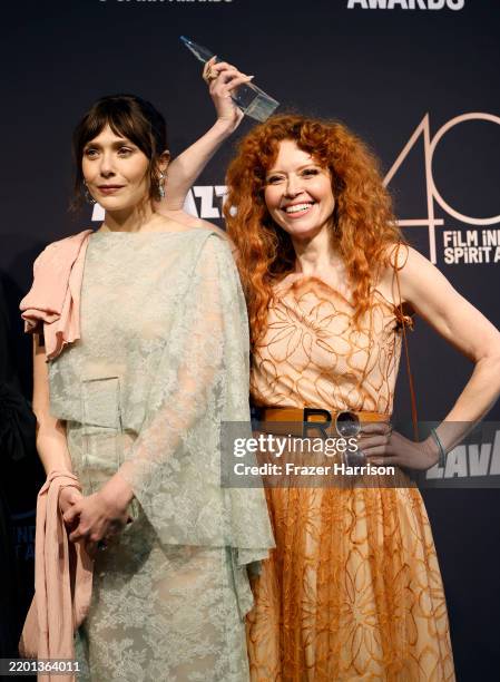 Elizabeth Olsen and Natasha Lyonne, winners of the Robert Altman award for "His Three Daughters," pose in the press room during the 2025 Film...