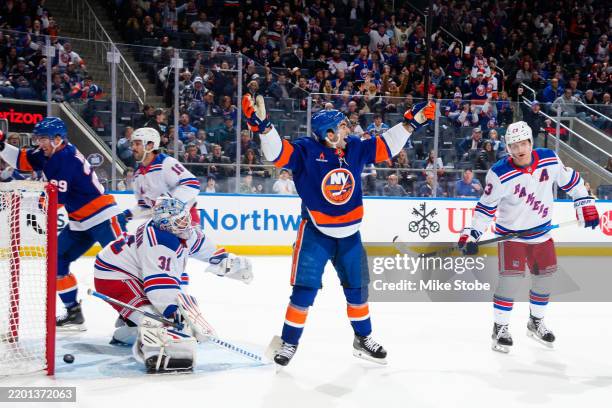 Kyle Palmieri of the New York Islanders celebrates a goal scored by teammates Alexander Romanov past Igor Shesterkin of the New York Rangers during...