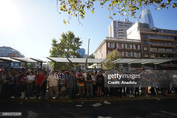 Chileans wait ar the bus station to return home after massive power outage has left 98.5% of the population without electricity in Santiago, which is...
