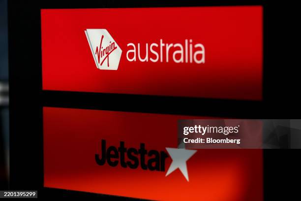 Signage for Virgin Australia Holdings Pty Ltd. And Qantas Airways Ltd.'s low-cost unit Jetstar Airways at Sydney Airport in Sydney, Australia, on...