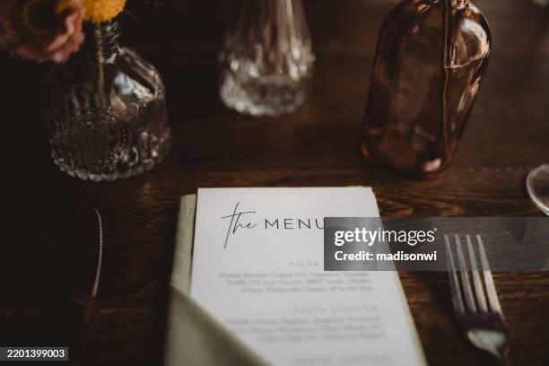 close up of menu at table setting - menu stockfoto's en -beelden