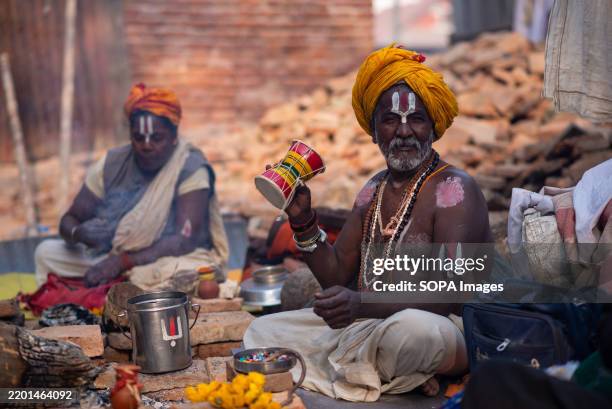 Sadhu or priest plays damaru, a traditional musical instrument during the festival. Maha Shivaratri is one of the biggest Hindu festivals celebrated...