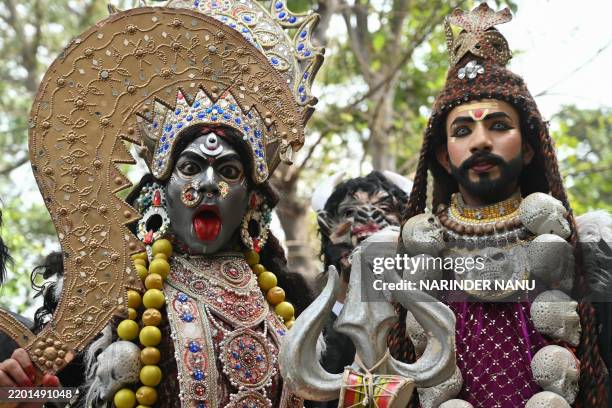 Artists dressed as Hindu deity Shiva and goddess Kali perform during a religious procession on the occasion of Maha Shivratri festival in Amritsar on...