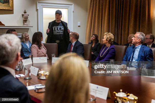 Leader of the Department of Government Efficiency Elon Musk wears a shirt that says "Tech Support" as he speaks during the first cabinet meeting of...