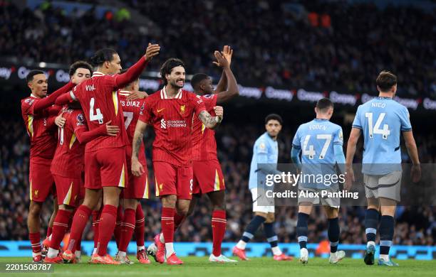 Mohamed Salah of Liverpool celebrates scoring his team's first goal with teammates during the Premier League match between Manchester City FC and...