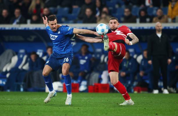 Jeff Chabot of VfB Stuttgart is challenged by Haris Tabakovic of TSG 1899 Hoffenheim during the Bundesliga match between TSG 1899 Hoffenheim and VfB...