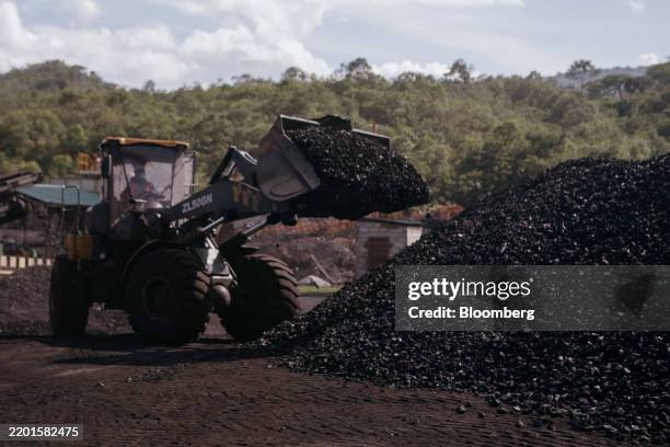 Worker drops coal onto a storage pile at the coal mining and processing facility in Mbeya region, Tanzania, on Tuesday, Feb. 25, 2025. Tanzania is...
