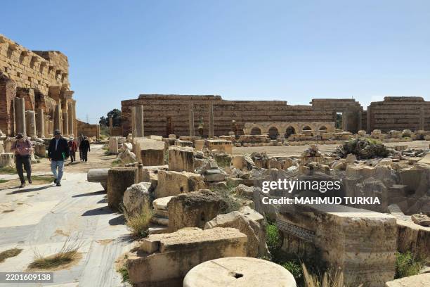 Tourists visit the ancient Roman city of Leptis Magna near the coastal Libyan city of Al-Khums, 120Km east of the capital, on February 27, 2025....