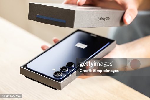 Person holds the new smartphone box or case and unpack it. Close up Person holds the new smartphone box or case and unpack it. Close up