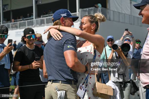 Jake Knapp hugs his girlfriend, Makena White, while walking off the 18th green during the first round of the Cognizant Classic in The Palm Beaches at...
