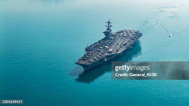 aerial view navy aircraft carrier at sea. - buque de guerra fotografías e imágenes de stock