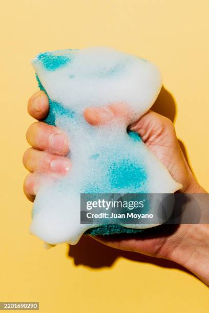 man grabbing a bath sponge full of soap foam - bath sponge stock pictures, royalty-free photos & images