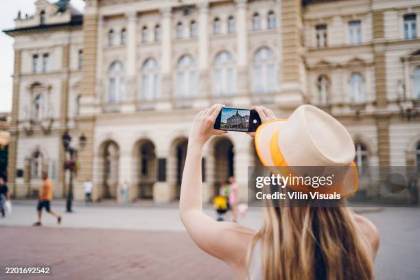 a young woman takes a photo the cathedral - photo shoot stock pictures, royalty-free photos & images