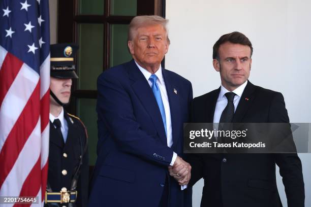President Donald Trump greets French President Emmanuel Macron as he arrives at the White House for a meeting on February 24, 2025 in Washington, DC....