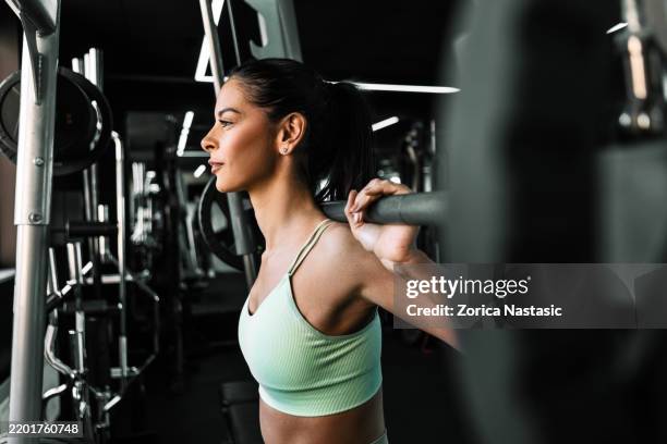 determined female athlete preparing to lift heavy weights - weightlifter stock pictures, royalty-free photos & images