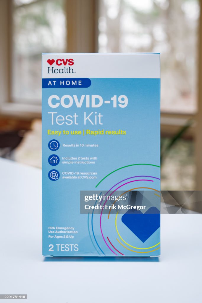 In this photo illustration, a box containing COVID-19 At-...